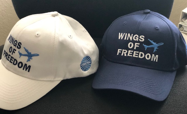 Caps celebrating Wings of Freedom