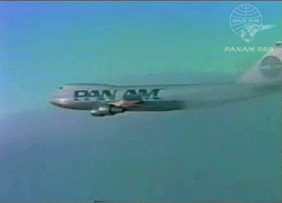 Pan Am Boeing 747 flying out of the clouds