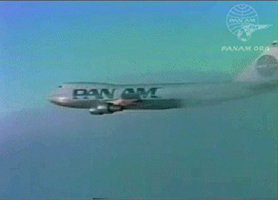 Pan Am Boeing 747 flying out of the clouds