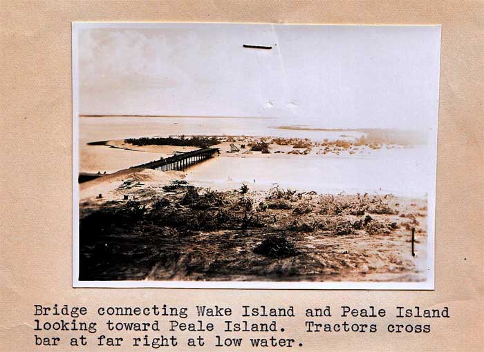 Bridge connecting Wake Island and Peale Island looking toward Peale Island Tractors cross bar at far right at low water (US National Archives Photo)