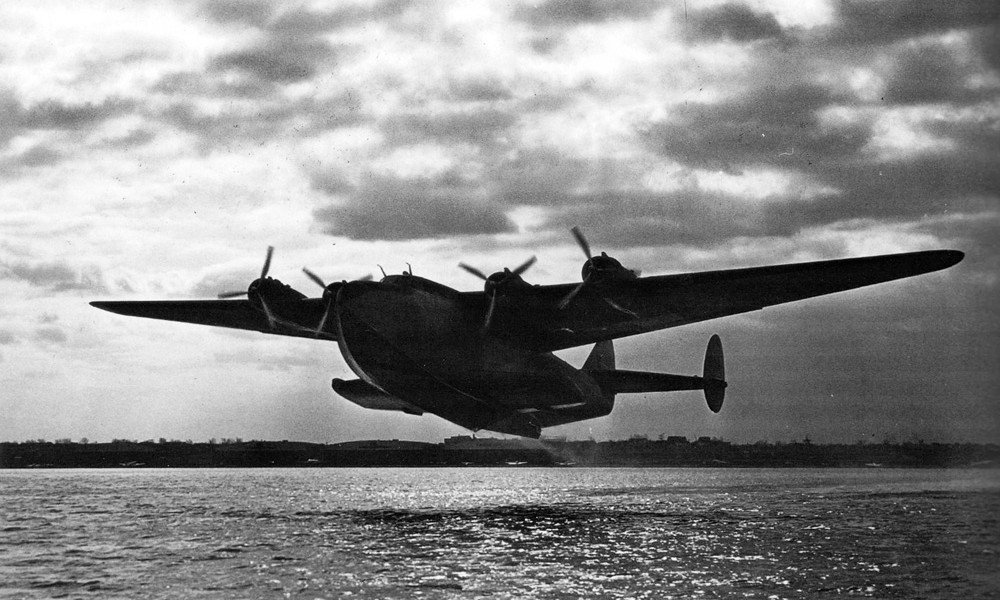 Pan Am Boeing 314 takes off at dawn during wartime, World War Two